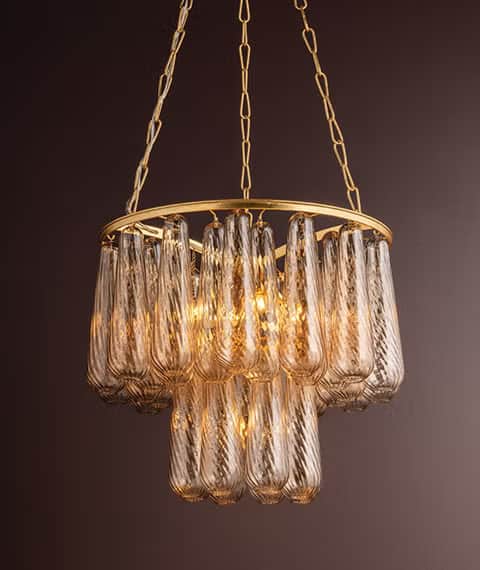 A contemporary tiered chandelier featuring a gold-finished metal frame and numerous textured, amber-… — free GLB 3D model