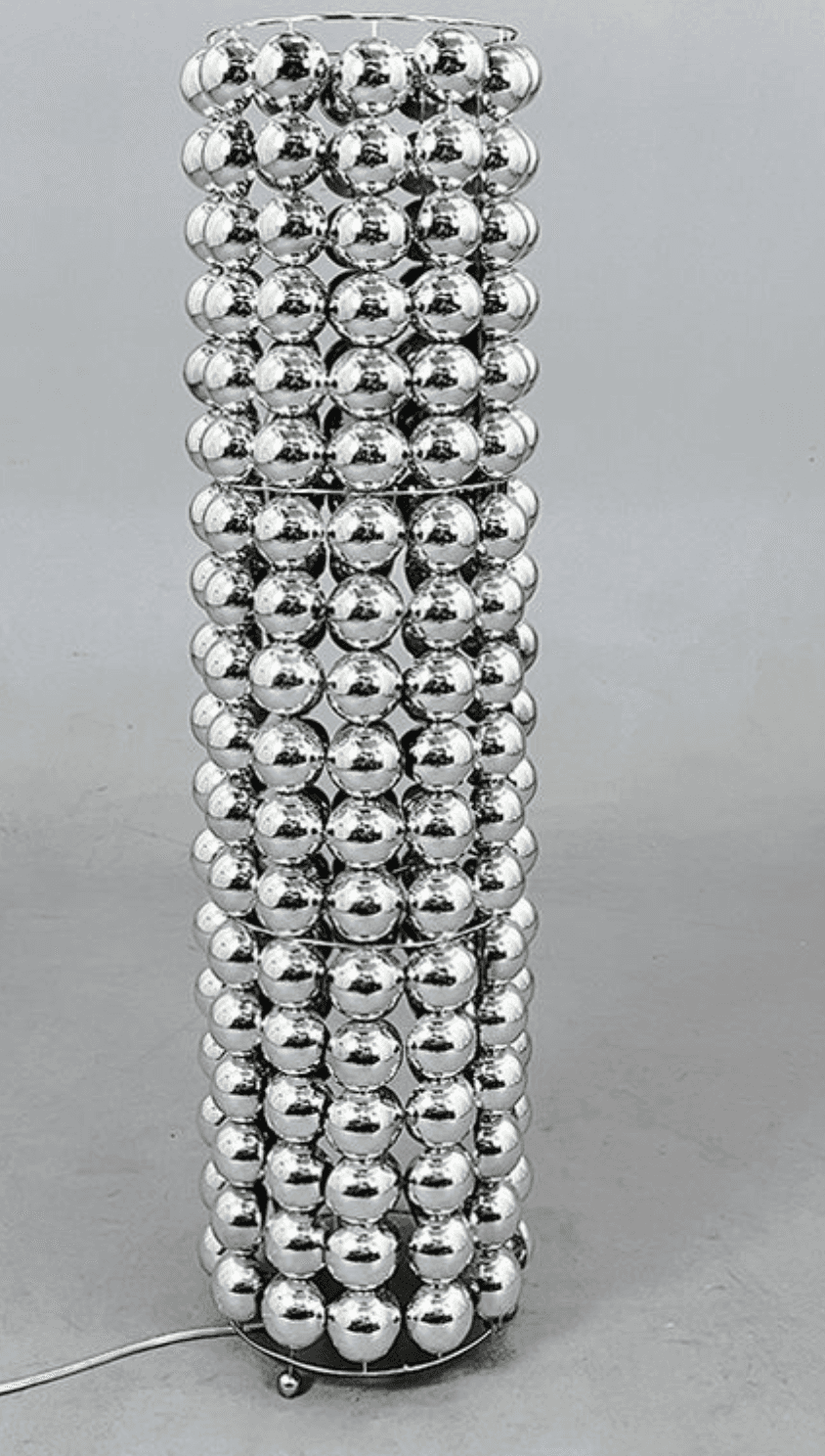 A tall, cylindrical floor lamp with a unique shade constructed from numerous small, spherical, refle… — 3D model
