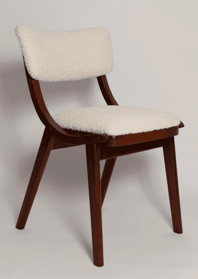 A contemporary armless chair featuring a dark brown wooden frame and a plush, cream-colored boucle u… — 3D model