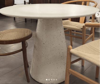 A light grey, round pedestal table with a conical base and a speckled concrete-like finish. — 3D model