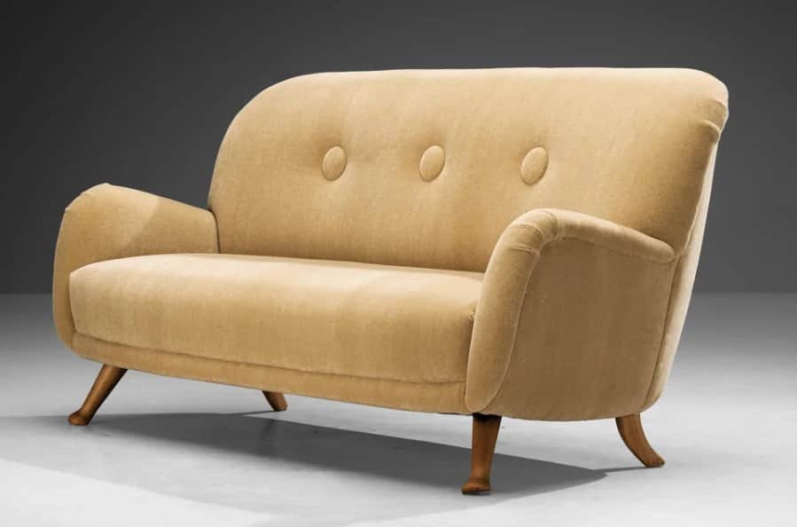 A two-seater sofa with a high, curved backrest and rounded arms. The upholstery appears to be a text… — 3D model