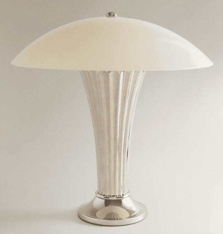A polished metallic table lamp featuring a ribbed or fluted stem and base, topped with a domed, opaq… — 3D model