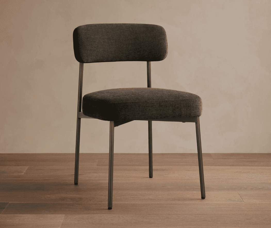 An armless upholstered chair featuring a dark gray fabric seat and backrest, supported by a slender… — 3D model