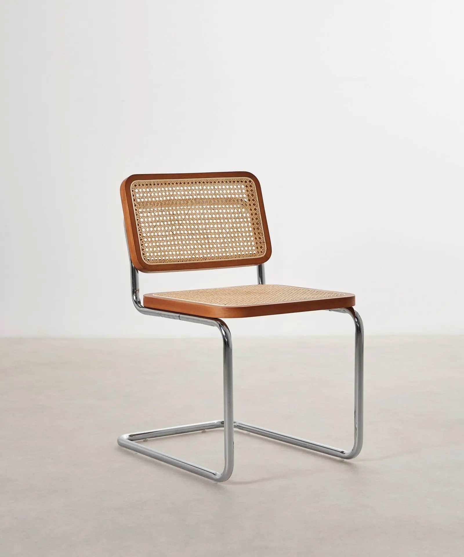An armless modern cantilever side chair featuring a polished chrome tubular steel frame and a seat a… — free GLTF 3D model
