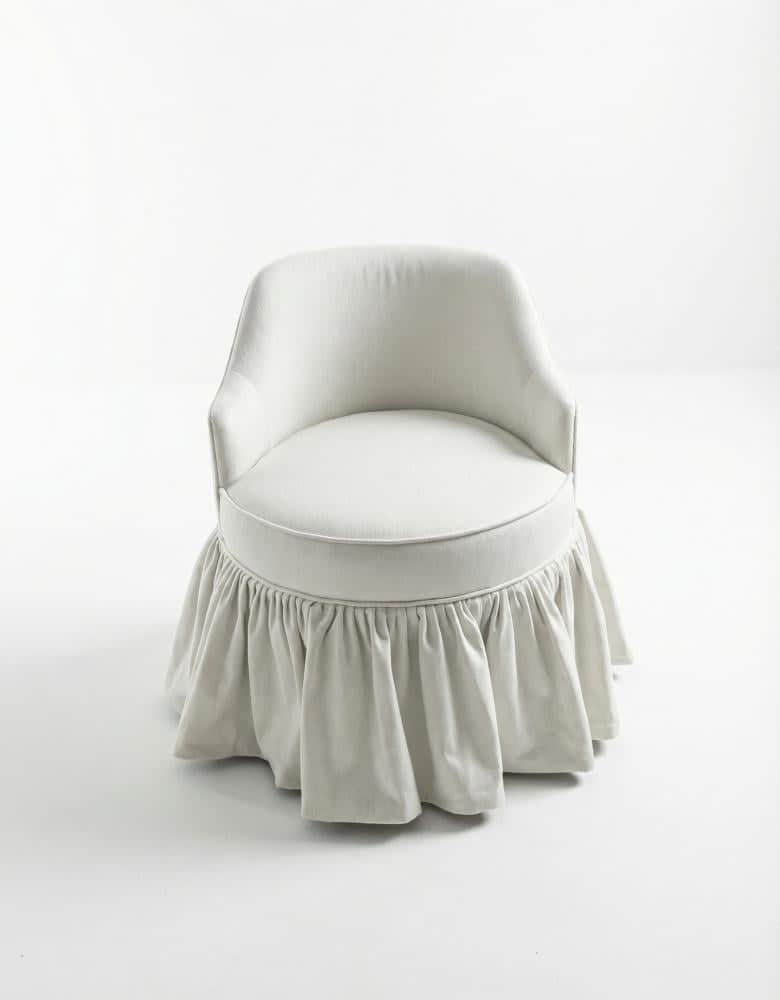 A compact, fully upholstered chair with a rounded back, low armrests, and a distinctive ruffled skir… — free FBX 3D model