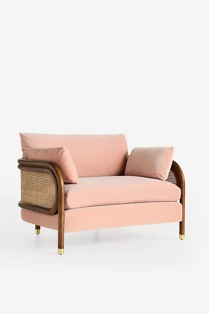 A modern lounge chair featuring a pink velvet upholstered seat and back, set within a dark wood bent… — 3D model