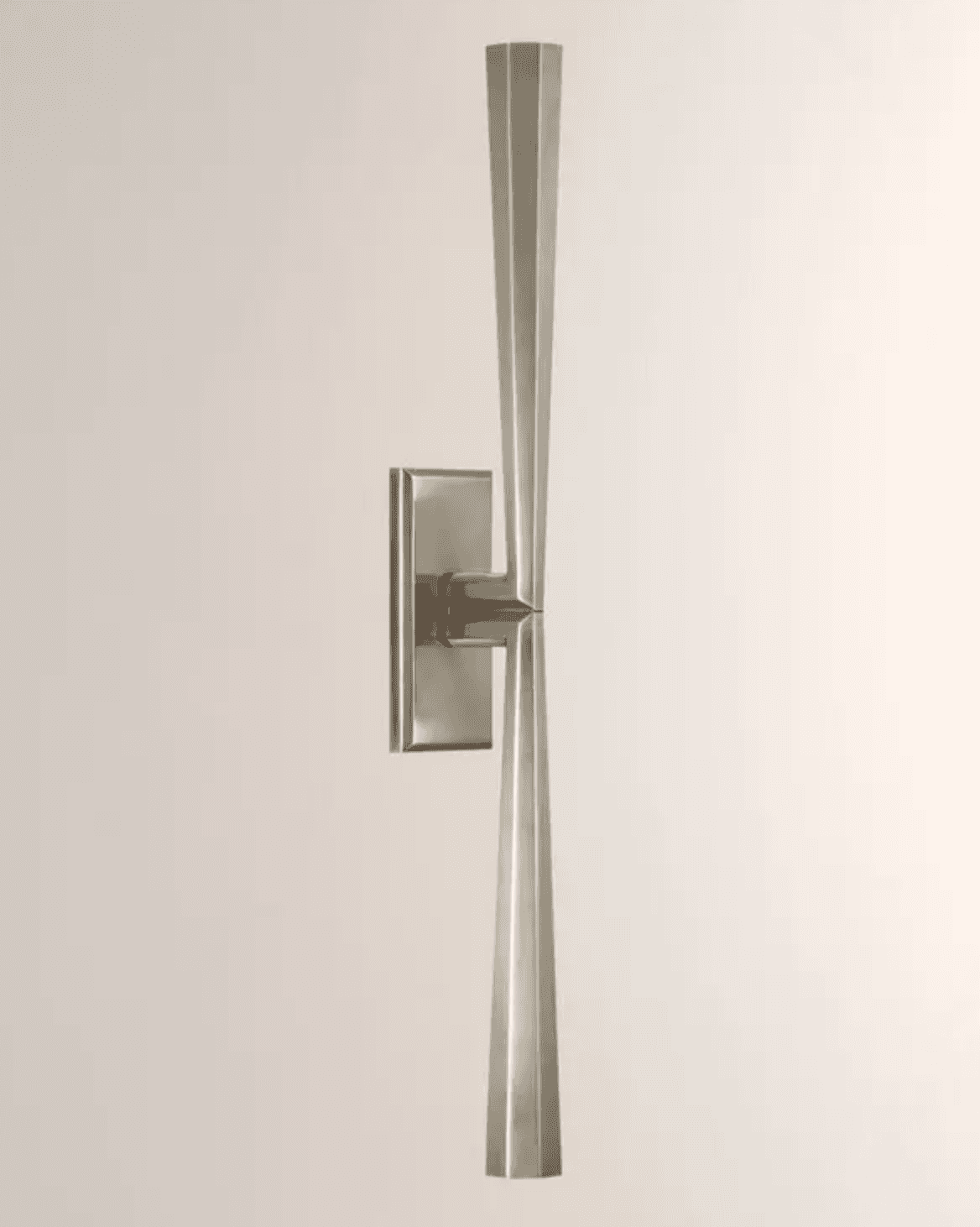 A contemporary wall sconce featuring a rectangular backplate and two symmetrical, elongated, taperin… — 3D model