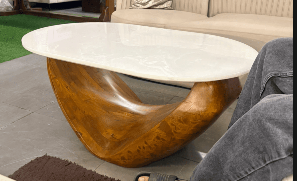 An organic modern coffee table featuring a large, smooth oval white tabletop resting on a dramatical… — free BLEND 3D model