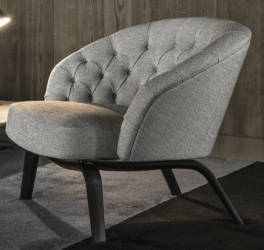 A modern armchair with a rounded, tufted backrest and a comfortably padded seat. The chair features… — 3D model