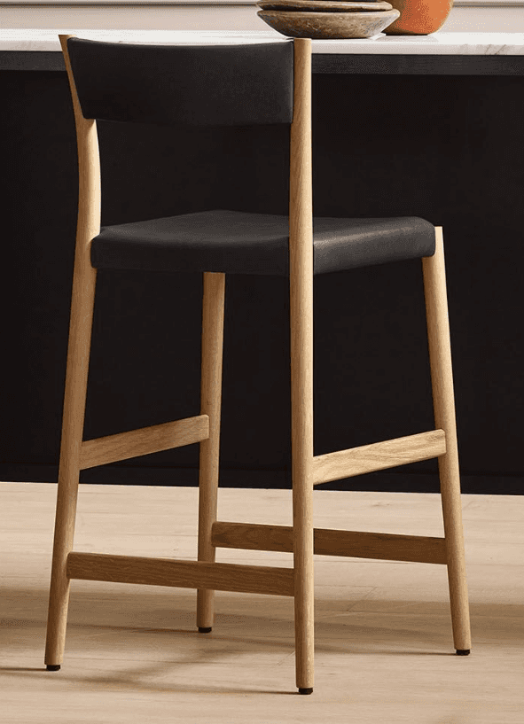 A contemporary bar stool with a wooden frame and a black upholstered seat and backrest. The stool fe… — free BLEND 3D model