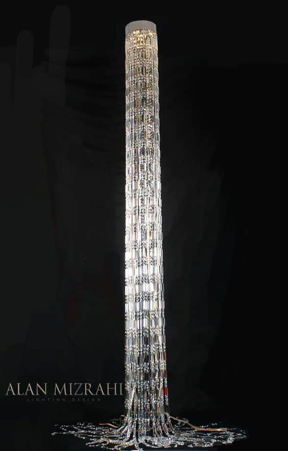A tall, slender, modern floor lamp featuring a cylindrical design composed of numerous clear, facete… — 3D model