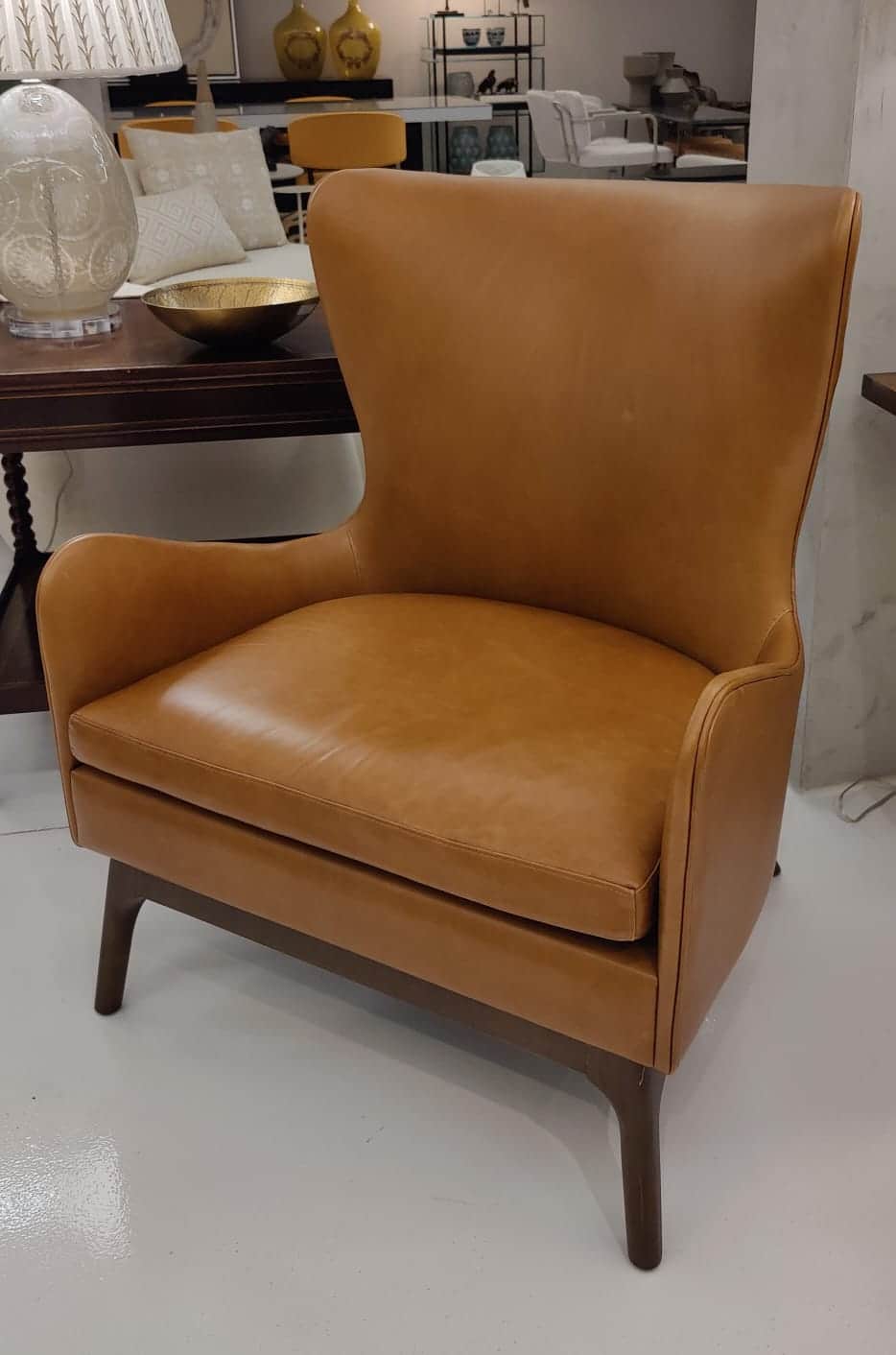 A contemporary high-back armchair upholstered in tan leather, featuring a comfortable padded seat cu… — free OBJ 3D model