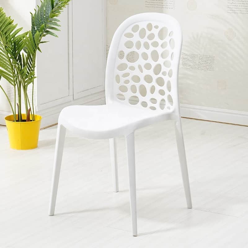 A modern white armless chair made of molded plastic, featuring a distinctive backrest with irregular… — free GLTF 3D model