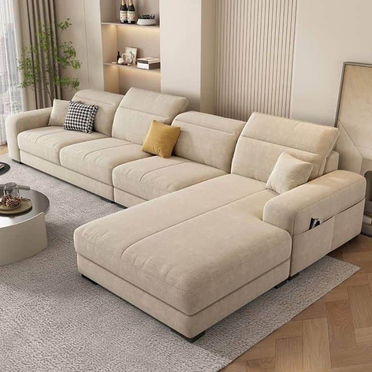 A modern, modular L-shaped sectional sofa upholstered in light beige fabric, featuring multiple seat… — 3D model