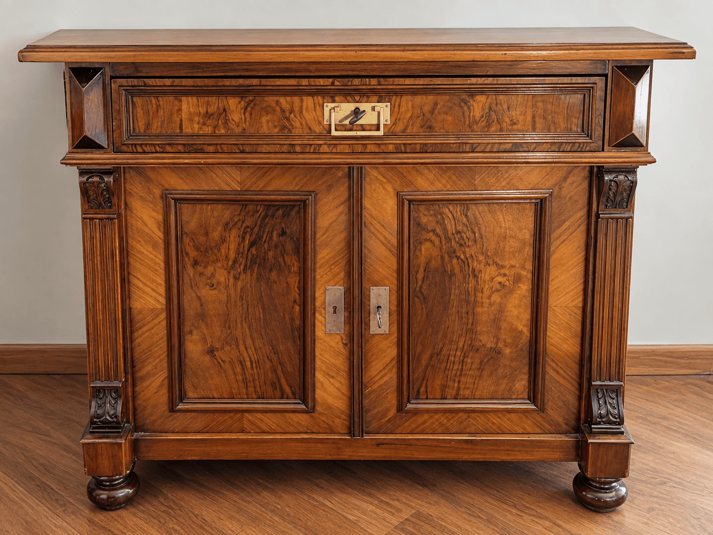 A traditional, dark wooden accent cabinet featuring a single drawer above two hinged doors, adorned… — 3D model