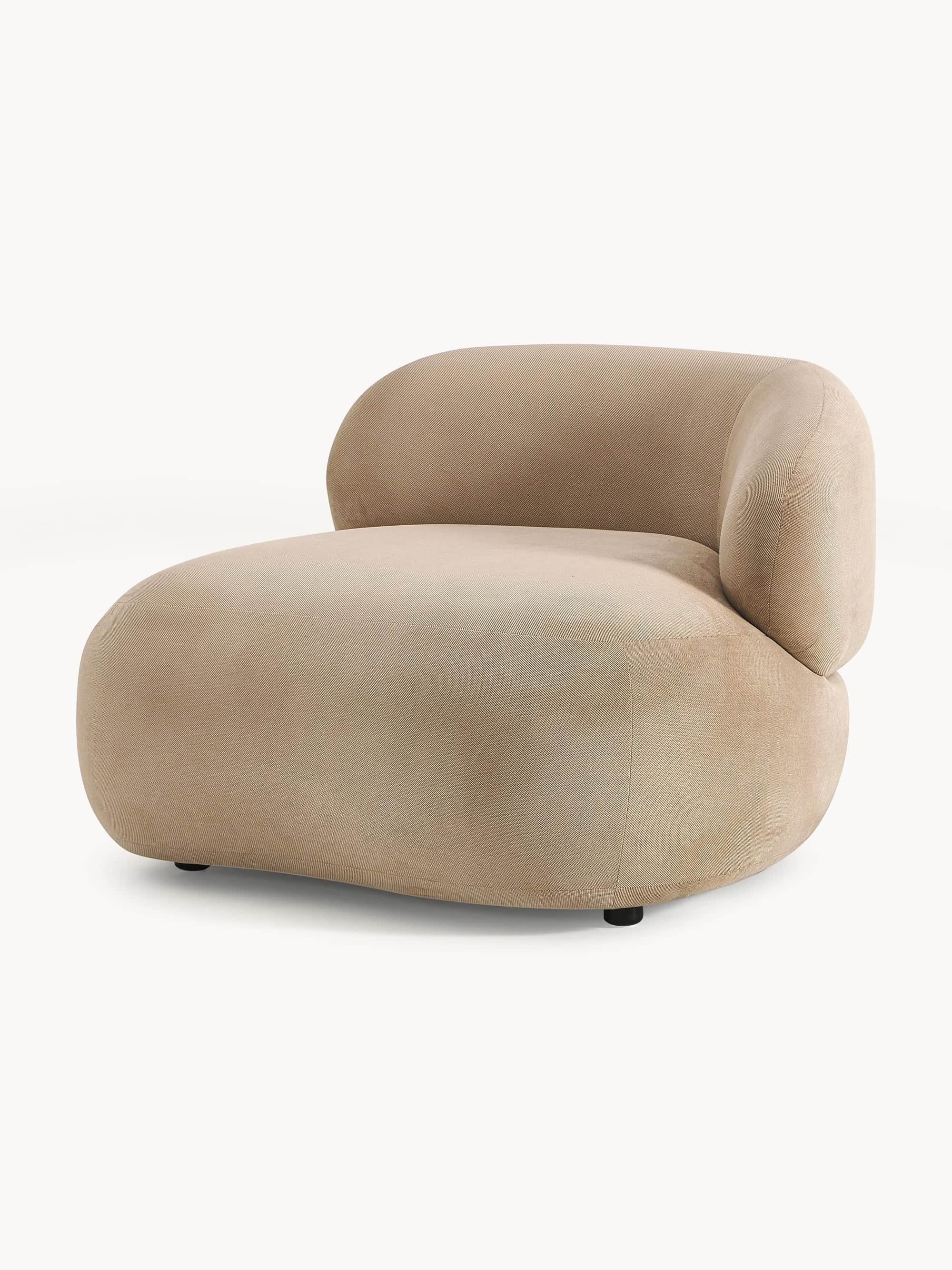 A contemporary armchair with a rounded, organic silhouette. It features a low profile with a deep se… — 3D model
