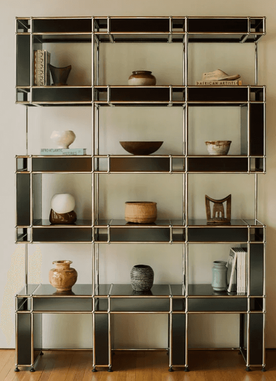 A tall, multi-level modular shelving and storage unit featuring a silver metal framework and black l… — 3D model