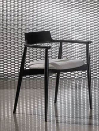 A modern dining chair with a black wooden frame, featuring a gently curved backrest that integrates… — 3D model