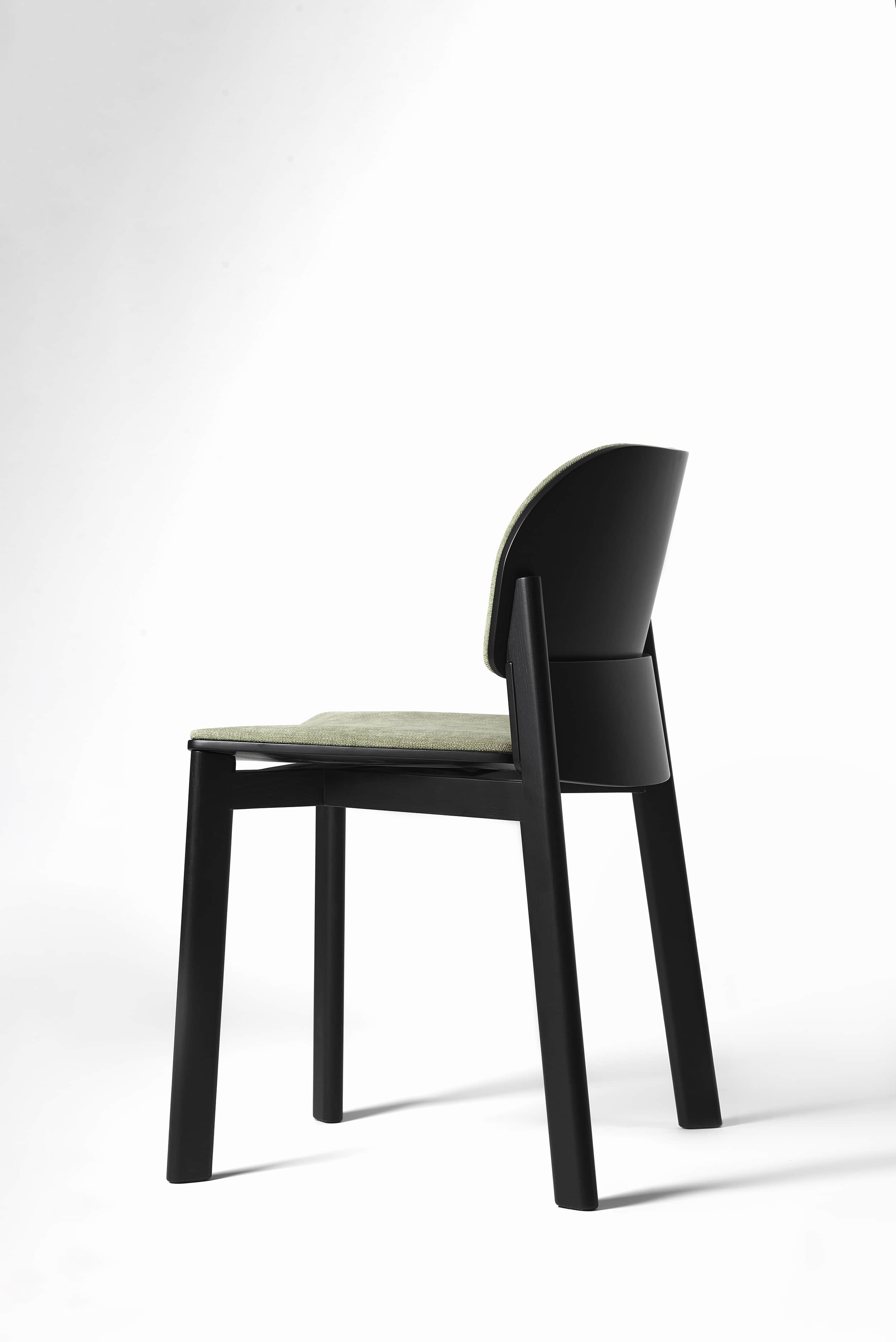 A modern dining chair featuring a black-finished solid wood frame, an upholstered seat cushion in a… — 3D model