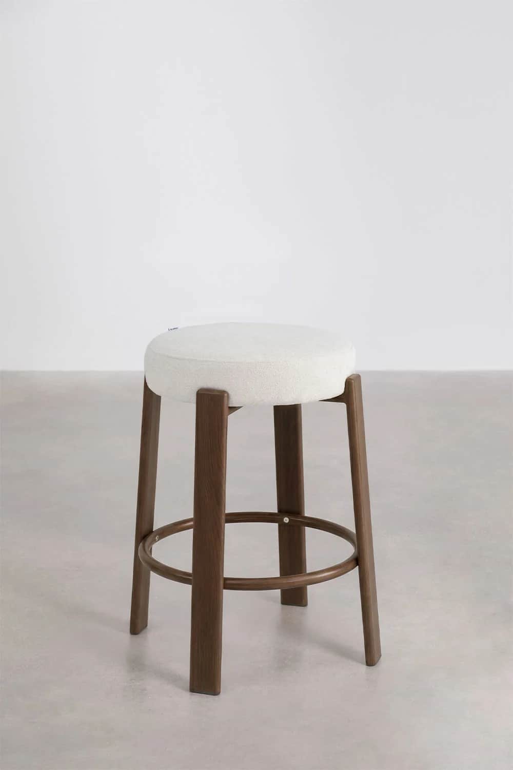 A contemporary bar stool featuring a round, thickly upholstered seat set atop a solid wood base. The… — 3D model