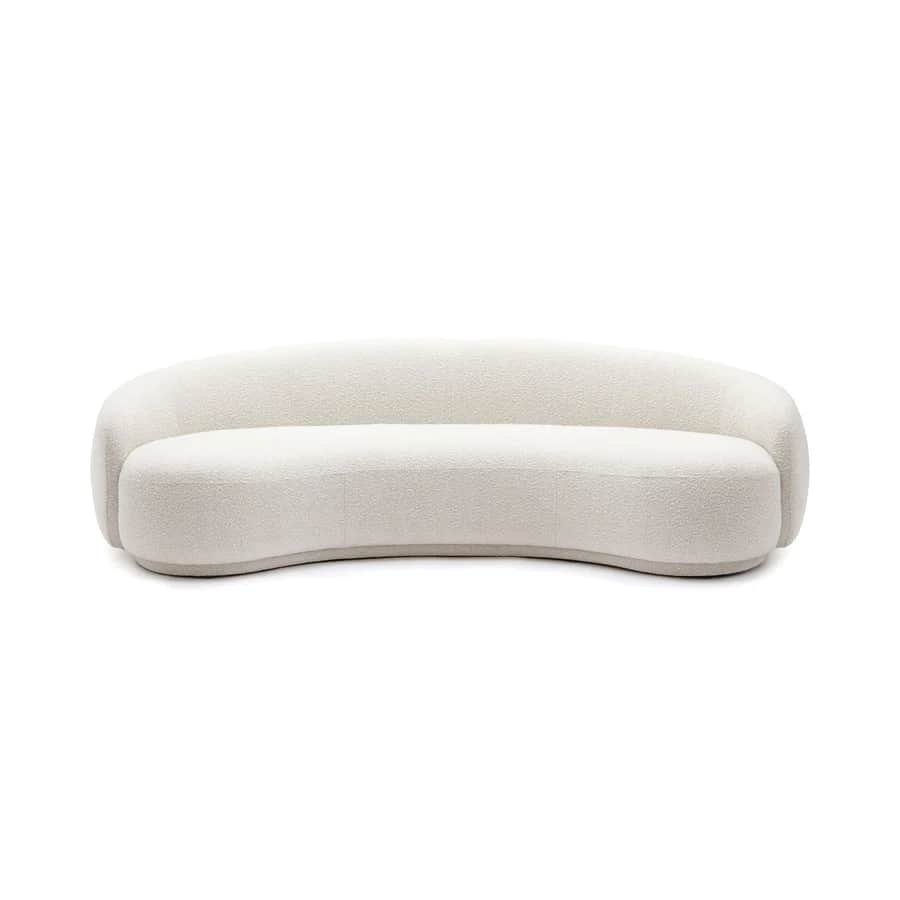 A contemporary curved sofa upholstered in a light-colored bouclé fabric, featuring a continuous, sea… — 3D model