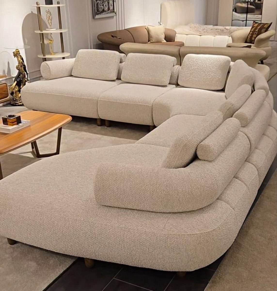 A large, light-colored, modular sectional sofa with multiple curved sections, upholstered in a textu… — 3D model