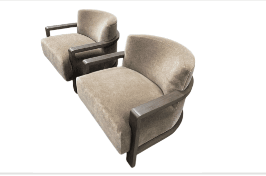Two upholstered armchairs with curved backs and wooden frames. The chairs feature plush, textured up… — 3D model