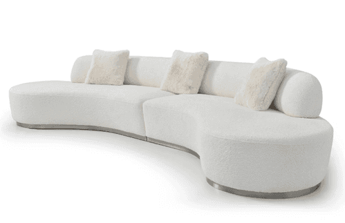A modern, modular, curved sofa with a textured white upholstery and integrated bolsters. The sofa fe… — 3D model