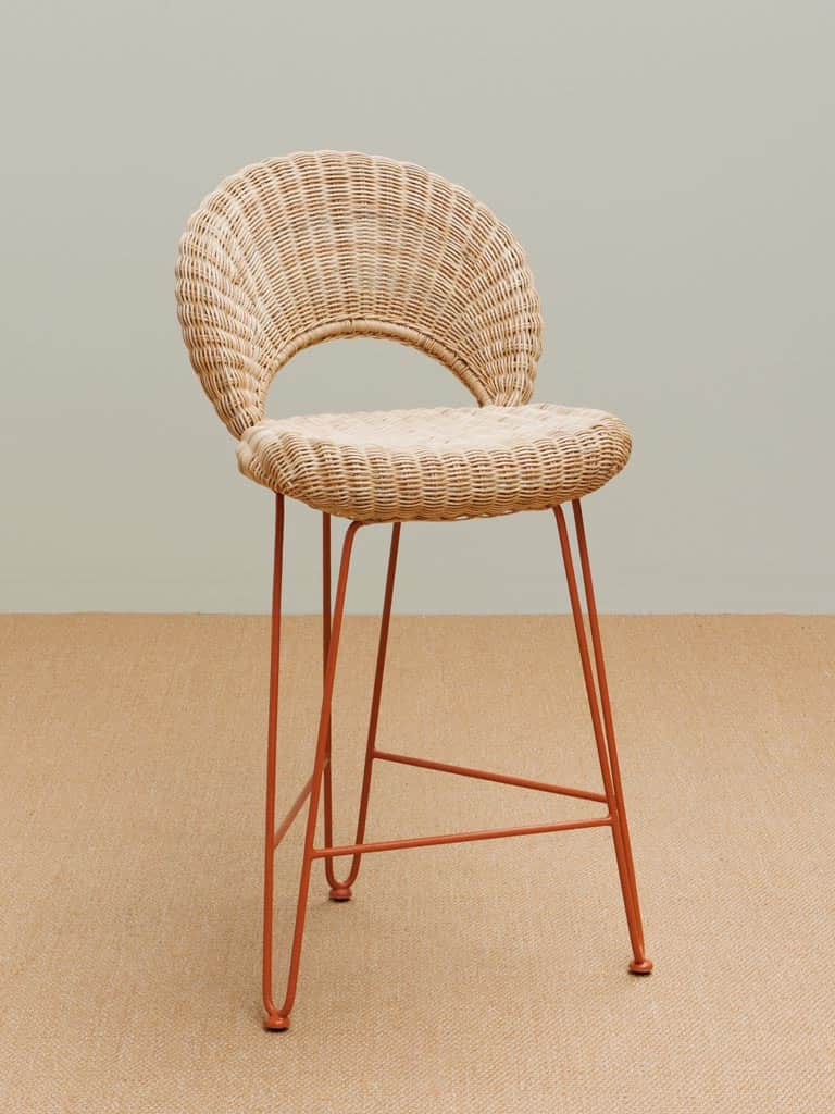 A contemporary bar stool featuring a woven rattan seat and a distinctive curved, open-back rattan ba… — 3D model