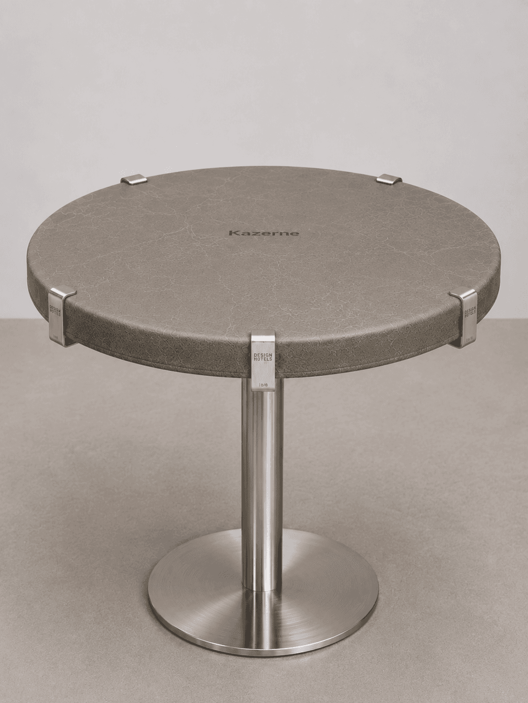 A contemporary round accent table featuring a textured grey upholstered top supported by a central b… — free FBX 3D model
