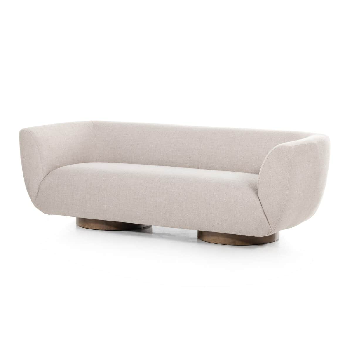 A modern sofa with a curved silhouette and a low-profile, round wooden base. The upholstery is a tex… — 3D model