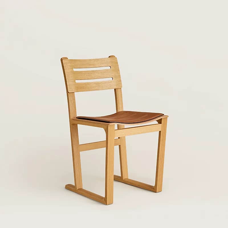 A modern wooden chair with a slatted backrest and a brown leather seat. The chair has a minimalist d… — free FBX 3D model
