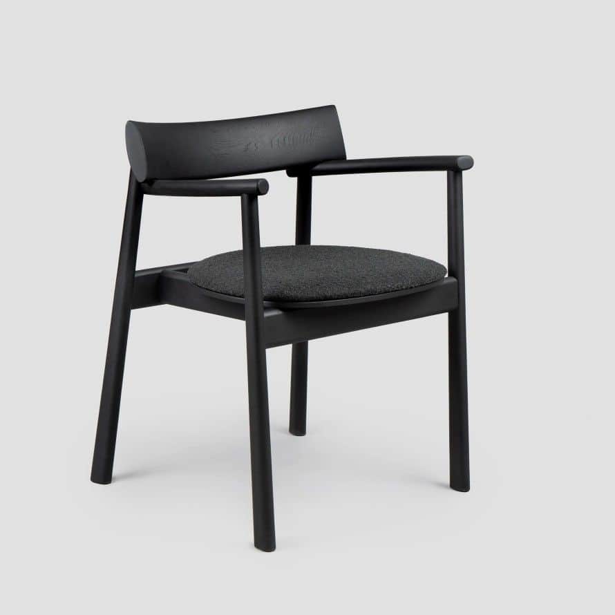 A modern dining armchair crafted from black stained wood, featuring an upholstered dark grey fabric… — 3D model
