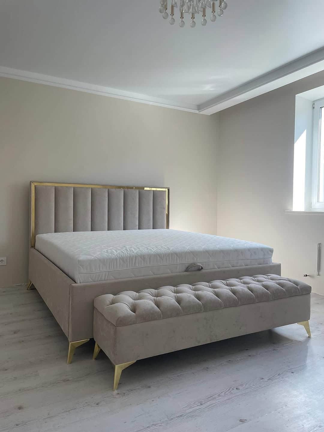 A modern platform bed featuring a tall, rectangular headboard with vertical channel tufting and a go… — 3D model