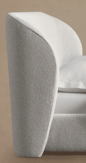 A close-up view of a modern upholstered bed frame, featuring a softly curved, enveloping headboard a… — 3D model