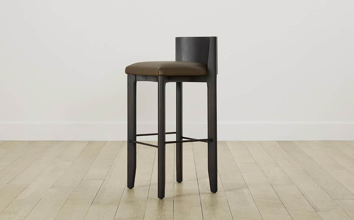 A modern bar stool featuring a dark stained wooden frame and a padded, upholstered seat with a low b… — 3D model