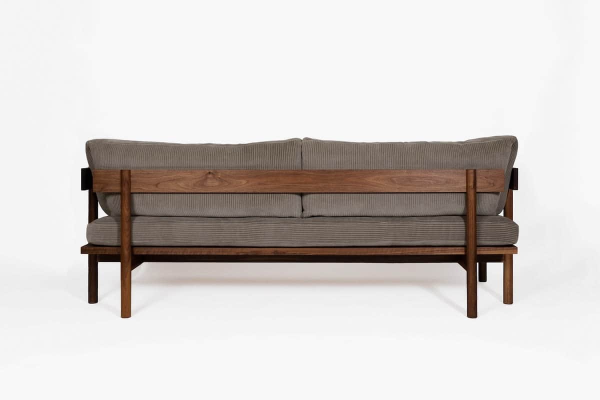 A contemporary loveseat featuring a robust dark wood frame and plush grey corduroy upholstery. The d… — 3D model