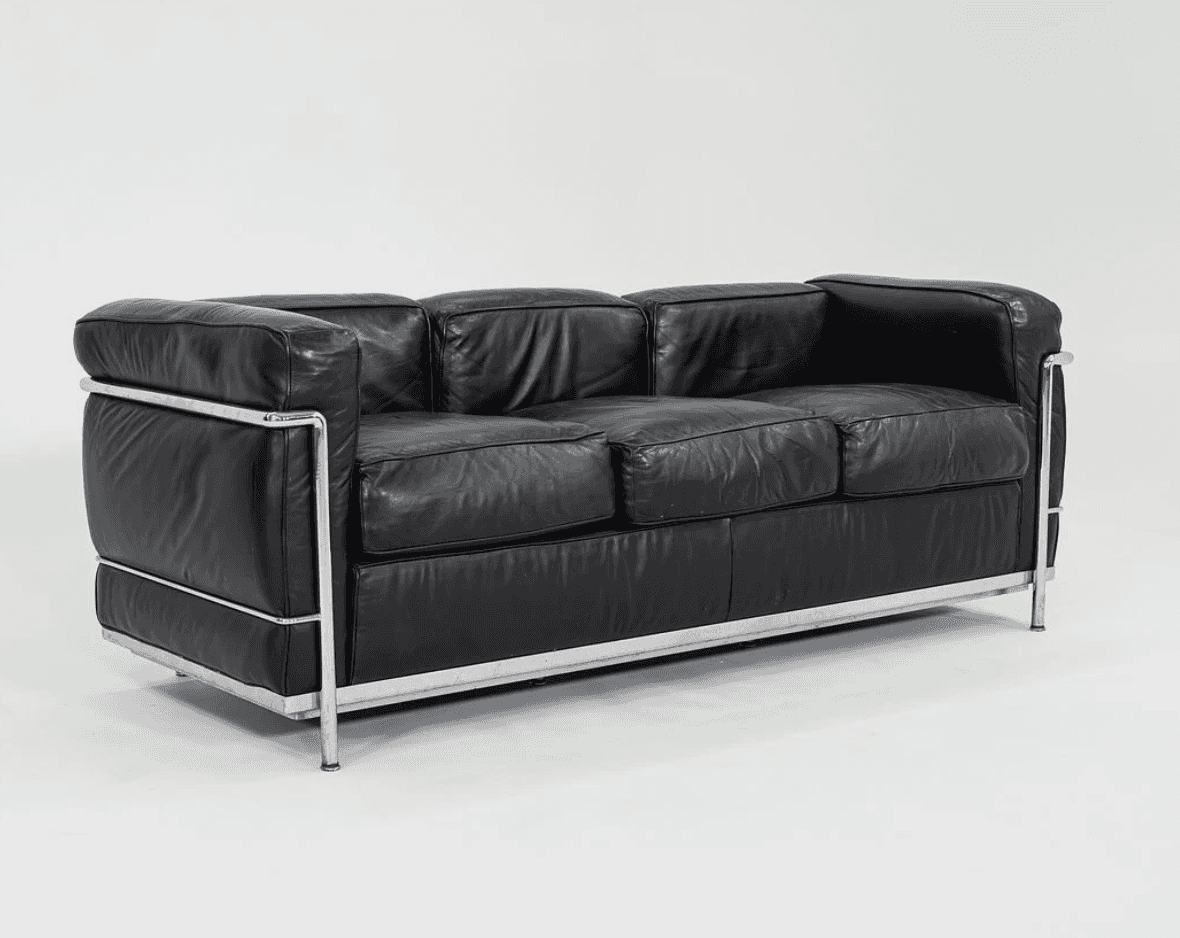 A three-seater sofa characterized by its boxy, geometric silhouette and exposed tubular chrome-plate… — free GLTF 3D model