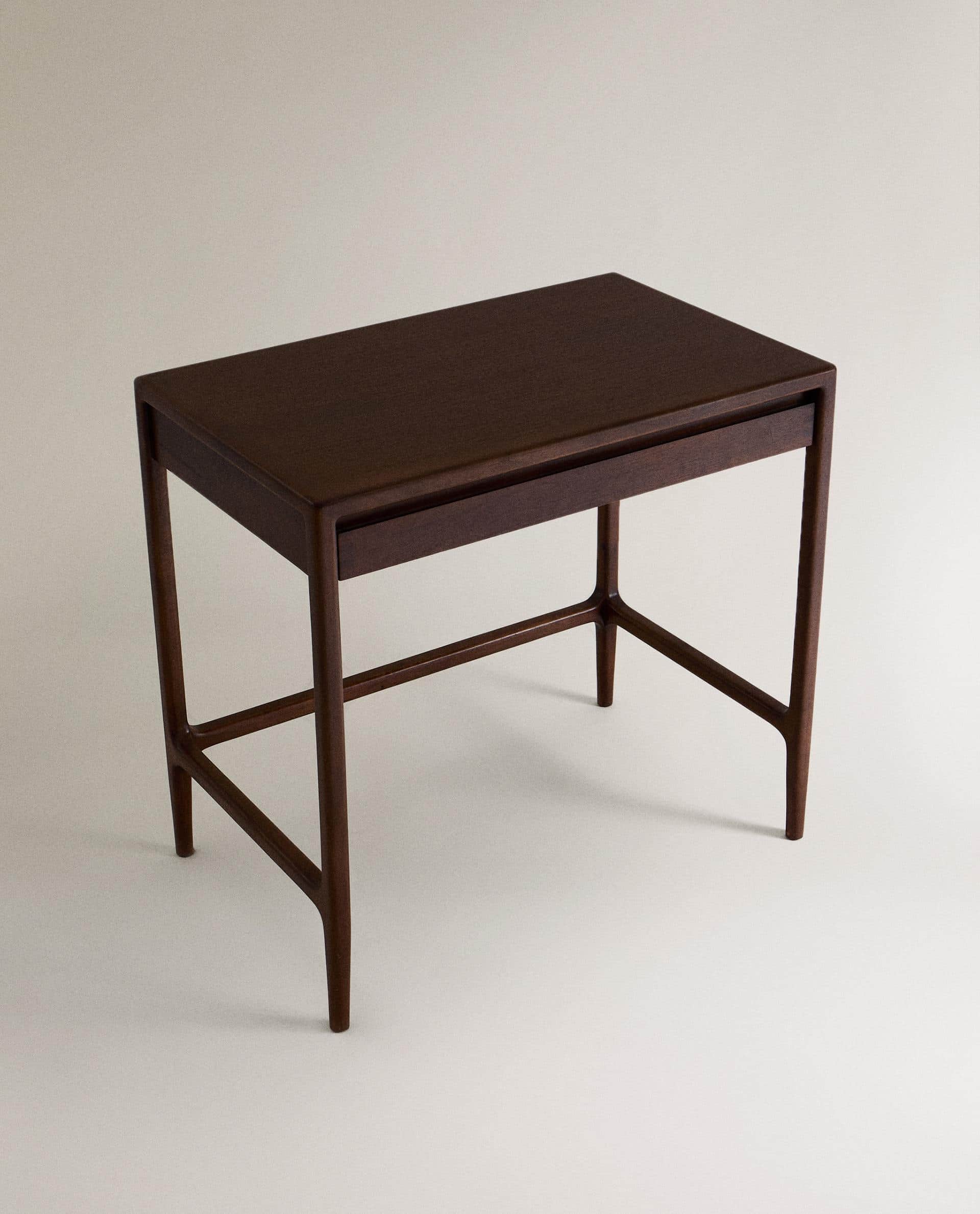 A minimalist dark wood writing desk featuring a rectangular top, a single shallow drawer, and four t… — 3D model