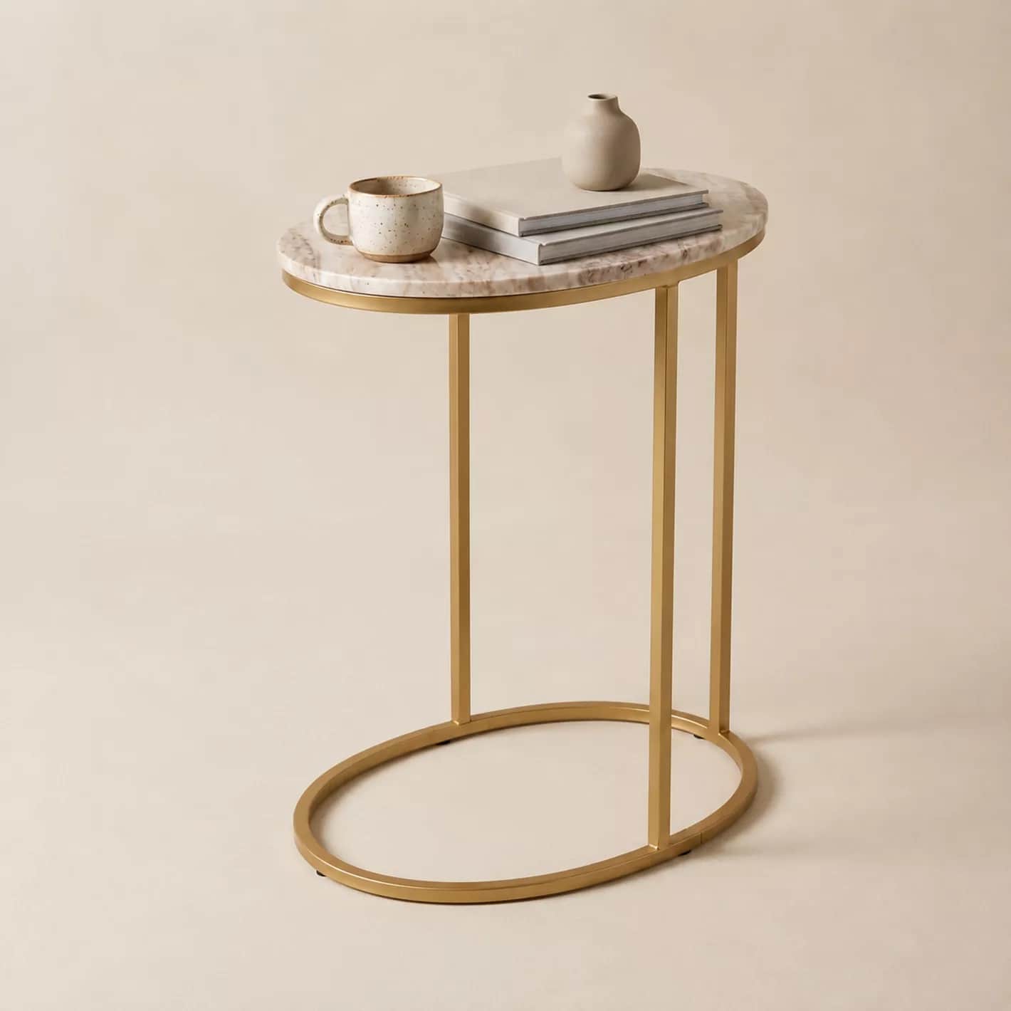 A modern C-shaped side table featuring an oval marble top and a gold-finished metal frame. The table… — free STL 3D model
