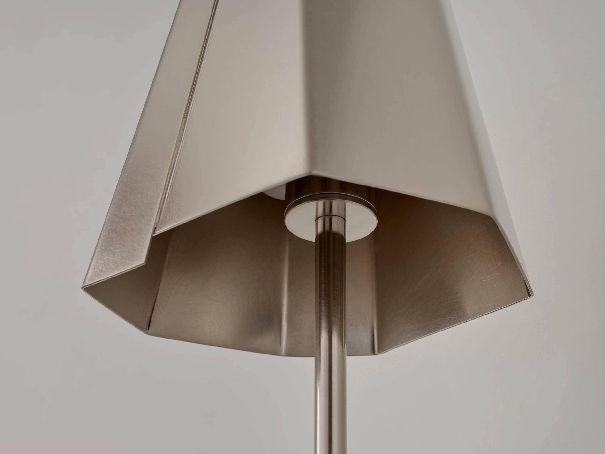 A close-up image of a modern pendant light's hexagonal, faceted shade, crafted from brushed metal. A… — 3D model