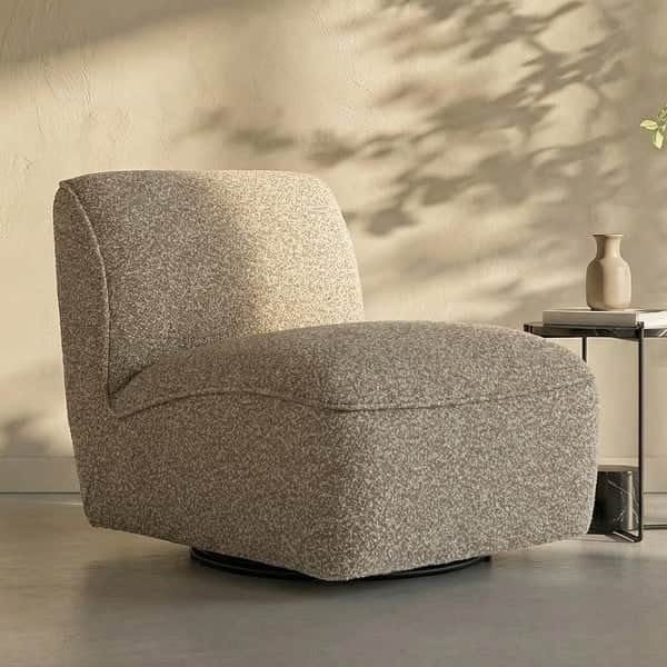 An armless lounge chair with a rounded, inviting silhouette, upholstered in a light-colored, texture… — 3D model