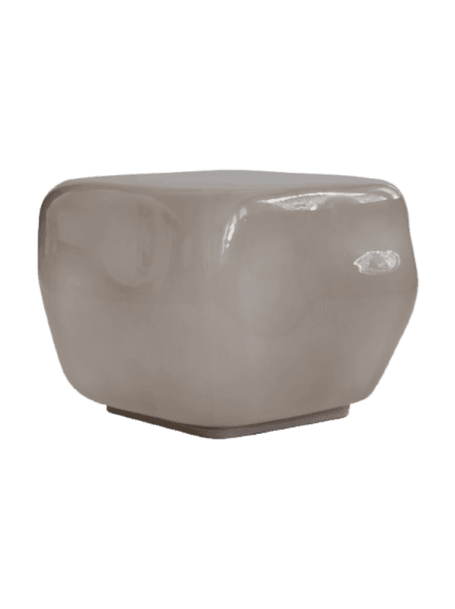 A modern sculptural side table featuring a rounded, cubic form and a glossy, smooth greige surface,… — 3D model