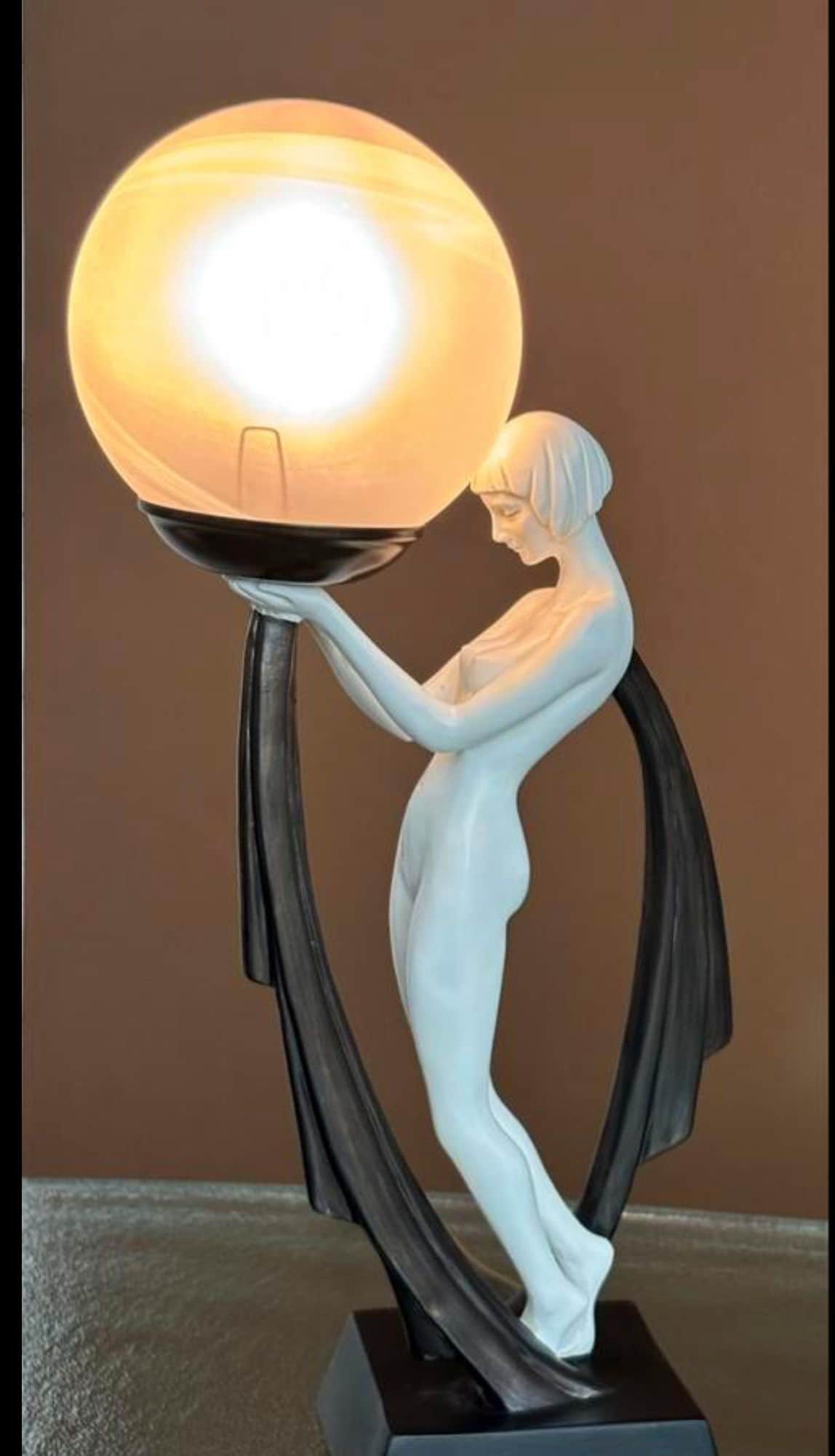 A striking Art Deco style figural table lamp featuring a nude female figure in a light finish, grace… — free OBJ 3D model