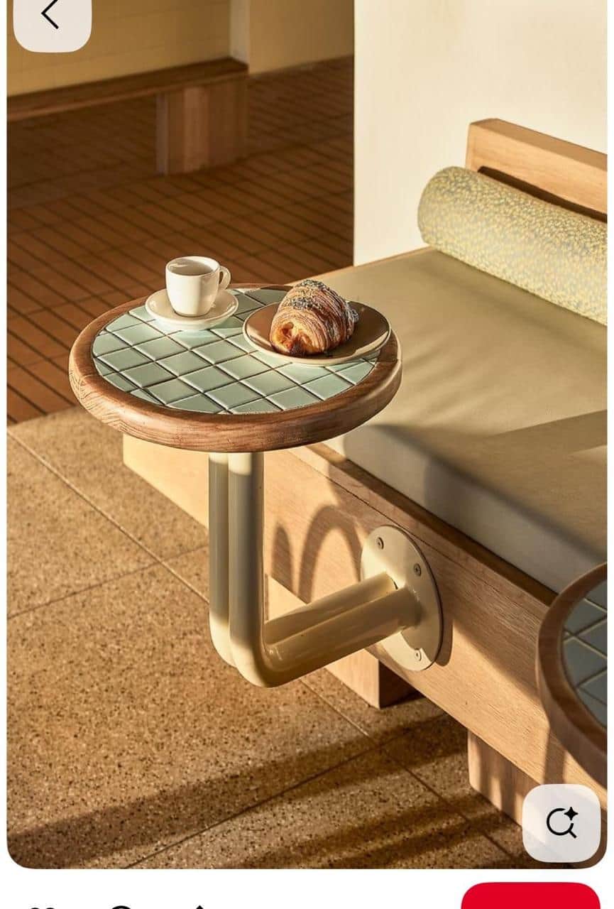 A small, round wall-mounted accent table featuring a wooden rim and an inlaid surface of small, ligh… — 3D model