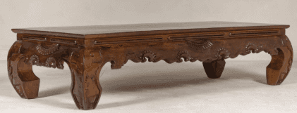 A low-profile rectangular table crafted from dark wood, featuring extensively carved details along i… — free BLEND 3D model