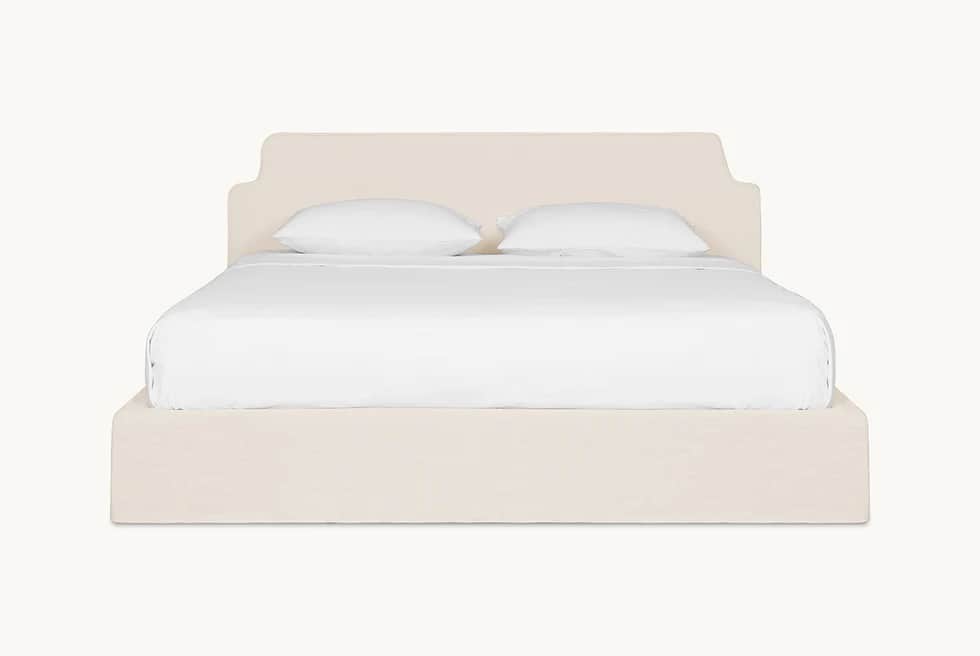 A bed frame with a padded headboard and platform base, covered in a neutral-toned fabric. The headbo… — 3D model