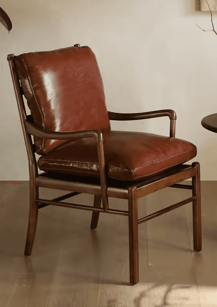 A rustic wood-framed armchair featuring plush, brown leather cushions. The chair has an exposed dark… — 3D model