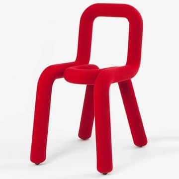 An avant-garde chair featuring a continuous, armless, tubular form upholstered in a vibrant red velv… — 3D model