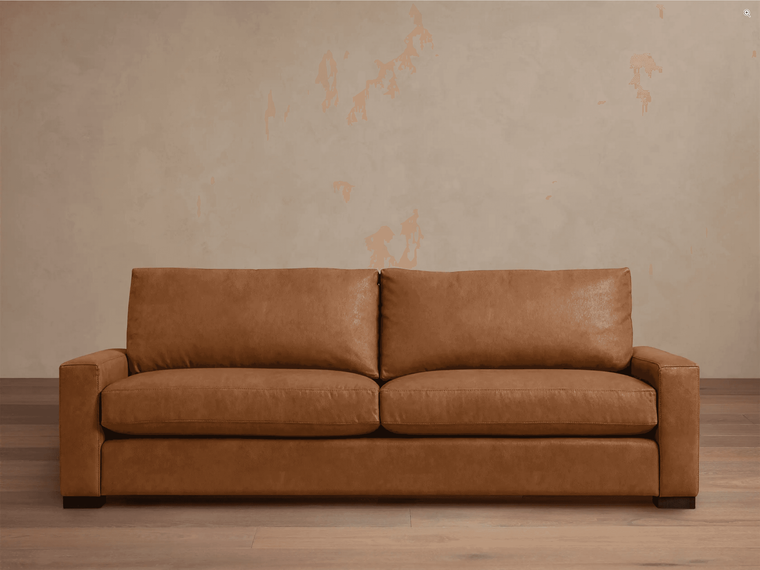 A contemporary two-seater sofa upholstered in a warm, light brown (cognac) leather, featuring clean… — 3D model